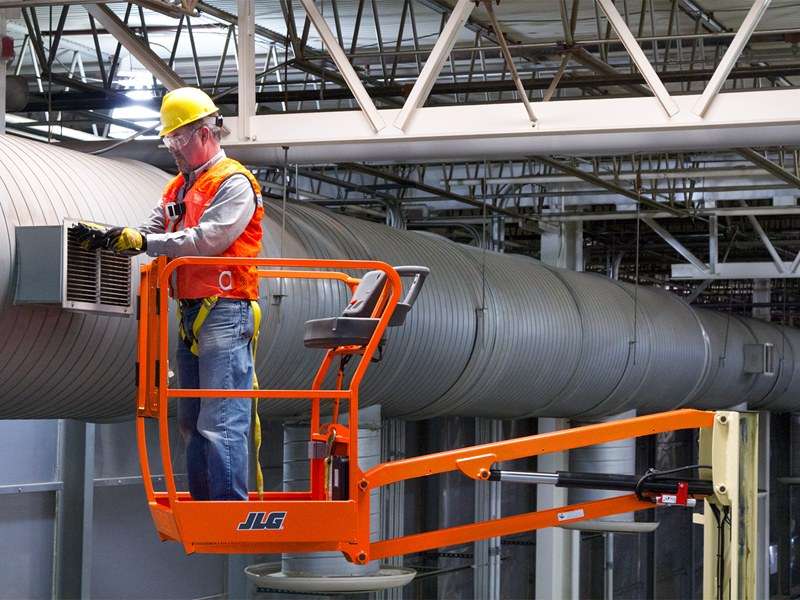 JLG Toucan 10E Mast Lift (WH 10.1m) repairing a high vent in a tight indoor space